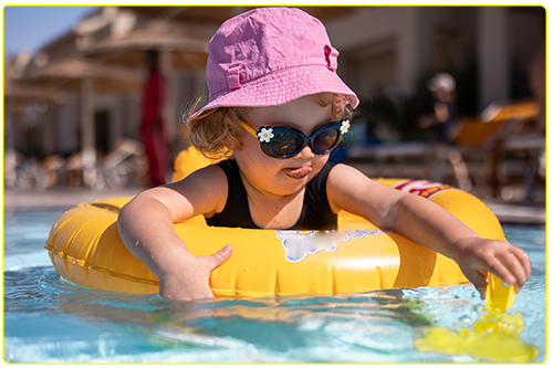 Image of a little girl floating in a pool on a rubber ring